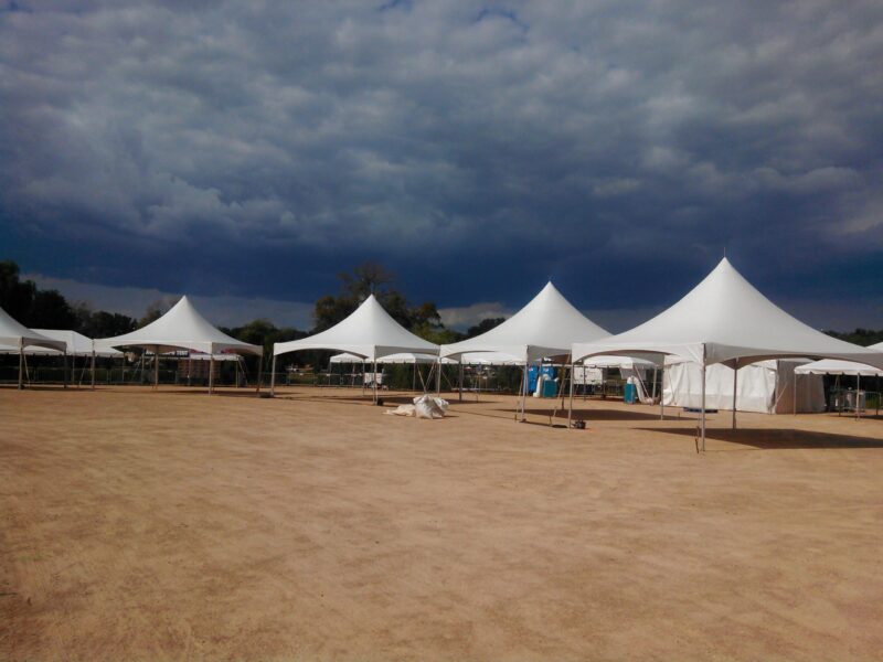 a group of tents in a dirt field