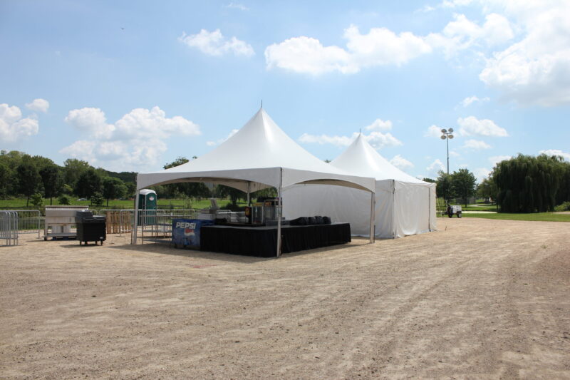 a white tent in a dirt field